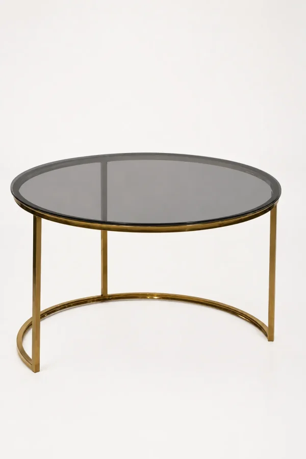 Luxury round smoked glass coffee table with gold crescent base featuring a dark tinted glass top and an open semi-circular metal foundation