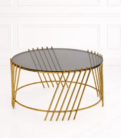 Luxury round smoked glass coffee table with gold slatted base featuring diagonal parallel metal rods extending past the glass top