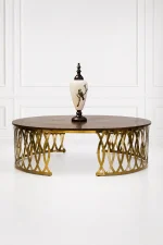 Luxury round wood coffee table with gold latticework base featuring a polished dark brown walnut grain top styled with a decorative white porcelain urn vase,