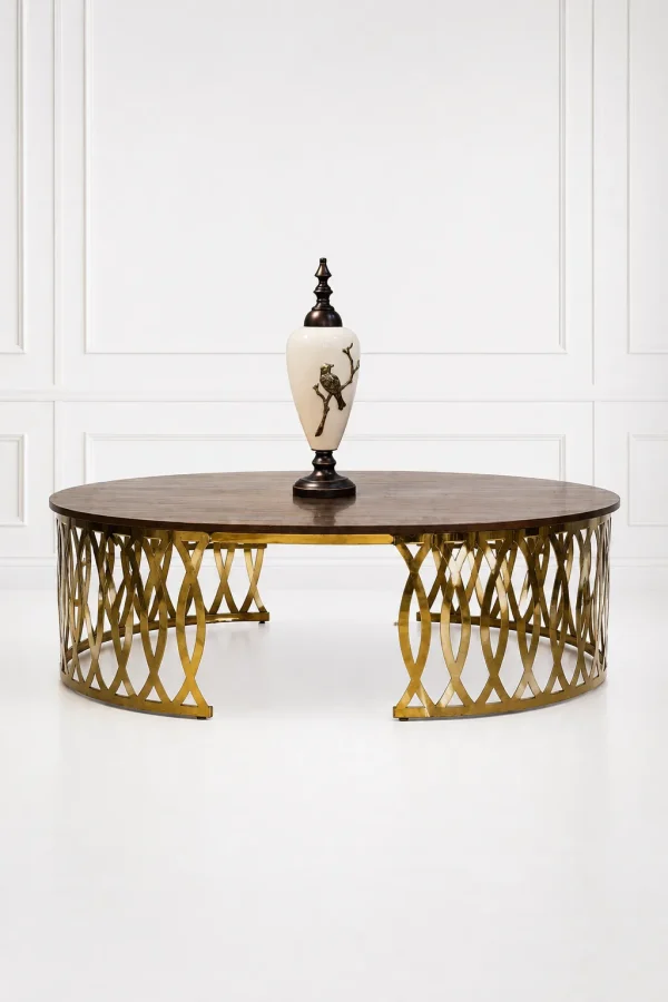 Luxury round wood coffee table with gold latticework base featuring a polished dark brown walnut grain top styled with a decorative white porcelain urn vase,