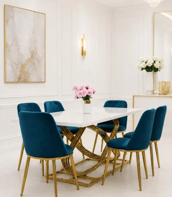 7 piece luxury dining set from featuring a rectangular white faux marble table with an interlocking gold ring base and six teal velvet dining chairs with tapered gold legs.