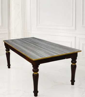 Rectangular luxury dark wood dining table featuring a grey textured wood-grain top, polished gold edge trim, and sculpted glossy dark legs with gold accent rings.
