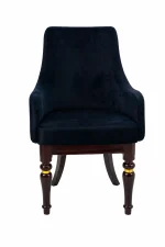 Luxury black velvet armchair featuring sloped armrests and sculpted dark wood legs with integrated polished gold ring accents, shown against a plain white background.