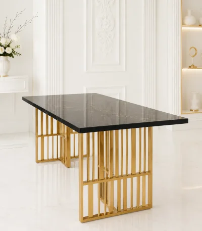 Luxury rectangular black marble dining table with natural gold veining, supported by open geometric vertical slatted gold legs in a bright white modern room.