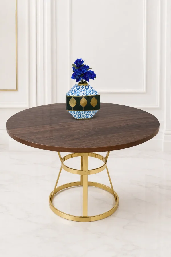 Luxury round dining table featuring a rich dark wood tabletop and a geometric polished gold stainless steel base with stabilizing metal rings, holding a decorative blue vase.