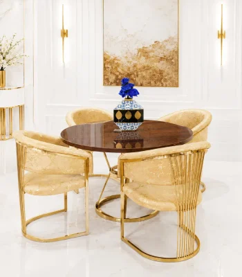 A luxury 4-seater round dining set featuring a high-gloss walnut wood tabletop on a circular gold stainless steel base, surrounded by four cream and gold patterned barrel chairs in a bright, modern white room with gold wall accents.