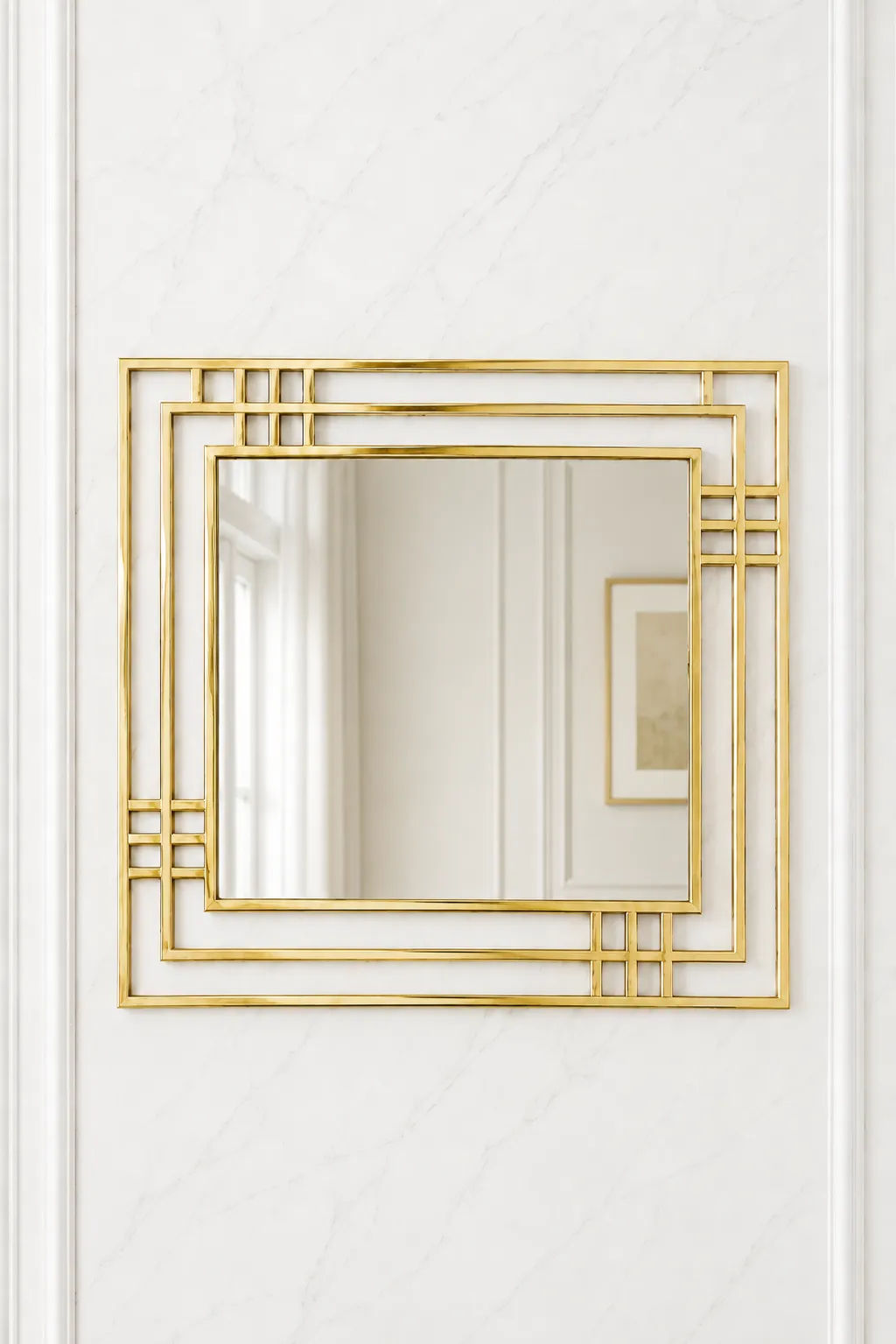 Modern Art Deco Square Gold Wall Mirror – Geometric Luxury Accent Mirror Square gold Art Deco wall mirror with a geometric multi-layered frame mounted on a minimalist white marble wall.