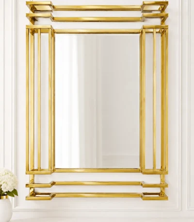 Luxury rectangular gold wall mirror with a tiered three-dimensional stainless steel frame hanging above a white marble console table.
