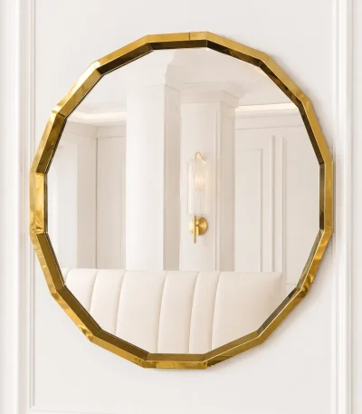 Luxury octagon gold wall mirror with a faceted geometric stainless steel frame mounted on a white paneled wall.