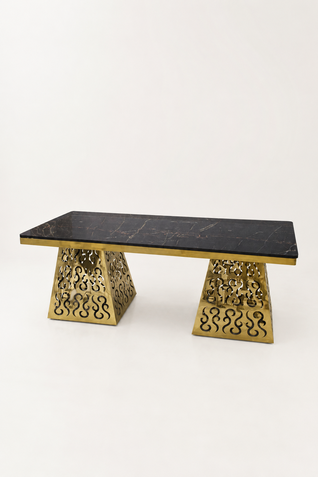 Luxury Console Table with Black Marble Top and Ornate Gold Laser-Cut Base A luxury rectangular console table featuring a polished black marble top and two ornate, laser-cut gold-finished metal bases.