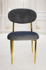 Modern grey velvet dining chair with gold metal legs and curved backrest.