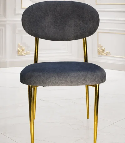Modern grey velvet dining chair with gold metal legs and curved backrest.