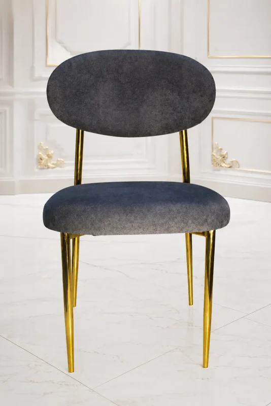 Modern grey velvet dining chair with gold metal legs and curved backrest.