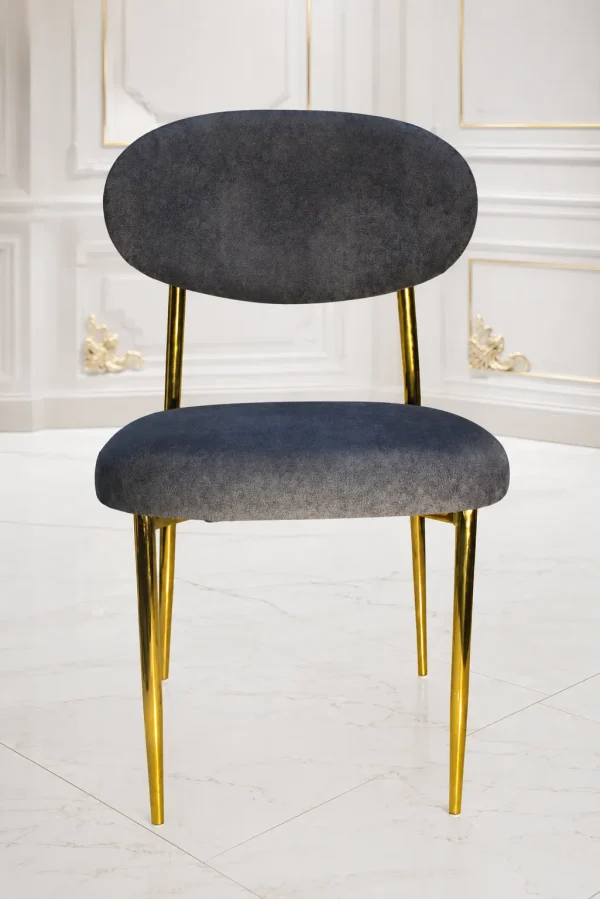 Modern grey velvet dining chair with gold metal legs and curved backrest.