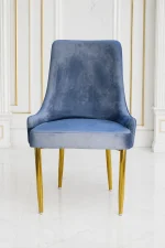 Modern quilted velvet dining chair featuring gold legs for elegant home interiors.