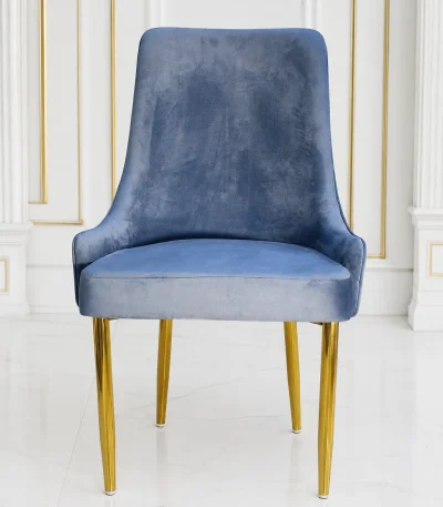 Modern quilted velvet dining chair featuring gold legs for elegant home interiors.