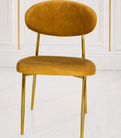 Luxury mustard velvet dining chair with gold metal legs for modern dining rooms and stylish interiors.