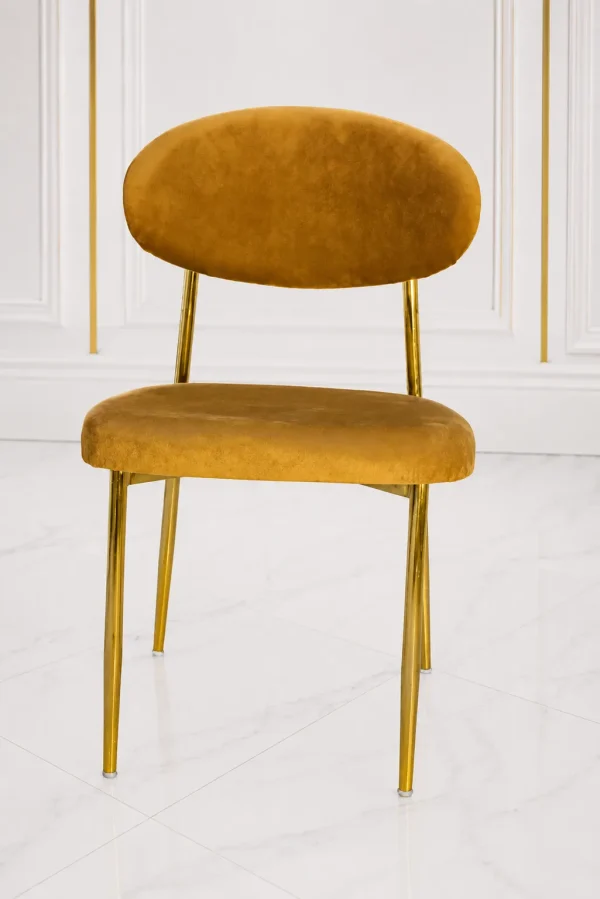 Luxury mustard velvet dining chair with gold metal legs for modern dining rooms and stylish interiors.