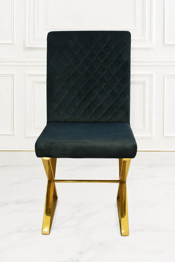 Luxury black velvet dining chair with diamond quilted back and gold stainless steel sled base.