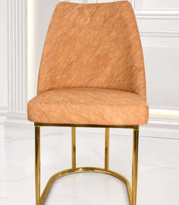 Luxury beige velvet dining chair with gold stainless steel sled base for modern dining rooms.