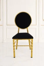 Luxury gold banquet chair with black velvet seat and round backrest for wedding and hotel seating.