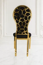 Modern upholstered black velvet accent chair featuring a high back and gold metal legs.