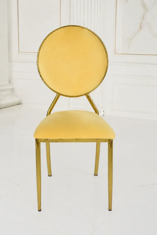 Modern gold stainless steel dining chair featuring a circular velvet backrest and elegant cream seat.