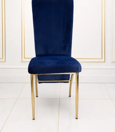 Luxury navy blue velvet dining chair with gold metal legs for modern dining rooms and hotels.