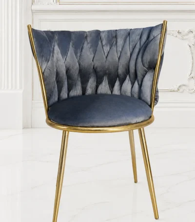 Grey velvet dining chair with gold metal frame and diamond pleated back