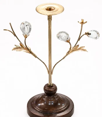 Luxury single candle holder with a polished gold stem, crystal bud branches, and a round dark wooden base against a white background.