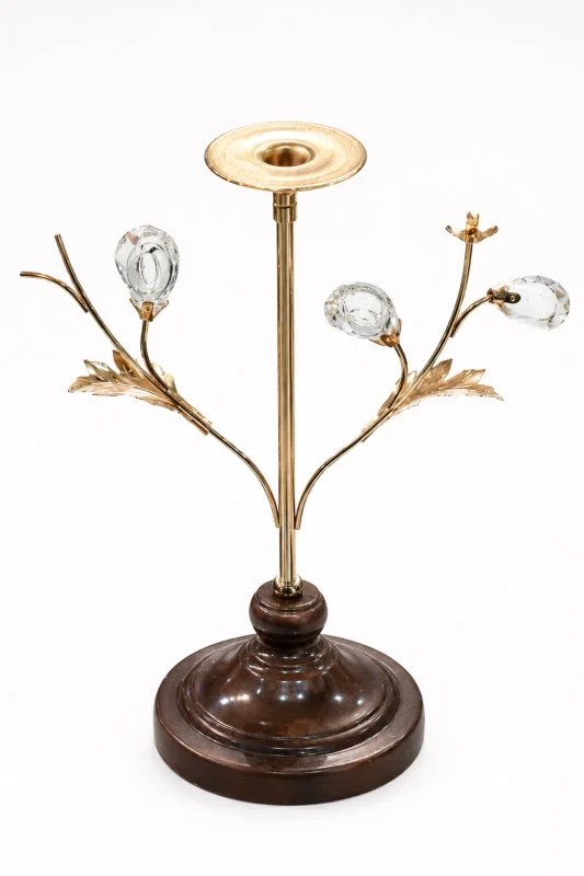 Luxury single candle holder with a polished gold stem, crystal bud branches, and a round dark wooden base against a white background.