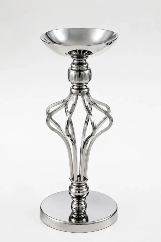 Contemporary silver pillar candle holder featuring a wide top bowl, an open twisted metallic cage stem, and a flat reflective circular base on a white backdrop.