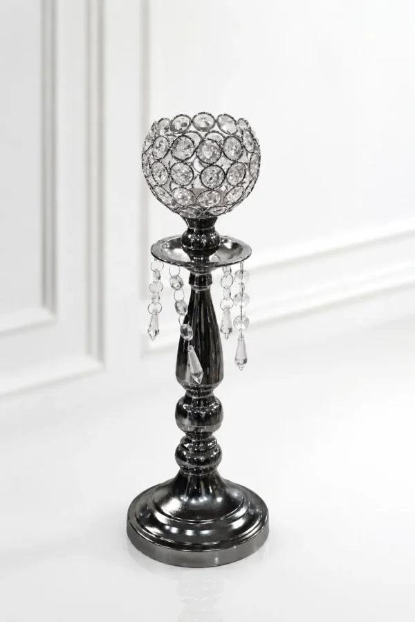 Glamorous gunmetal black crystal candle holder featuring a beaded crystal goblet, hanging crystal teardrop prisms, and a dark metallic tiered pedestal base on a glossy white surfac