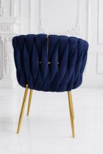 Luxury navy blue velvet dining chair with gold metal legs and scalloped backrest.