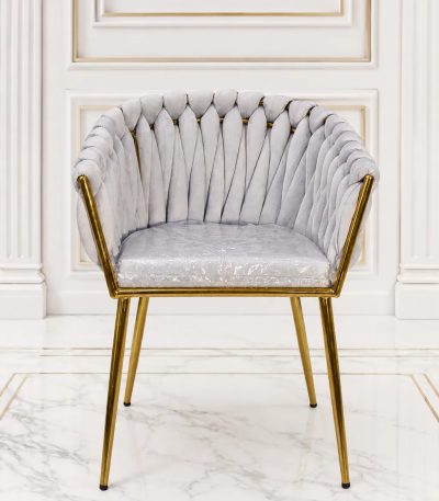 Luxury light grey velvet dining chair with gold metal legs and scalloped shell backrest.