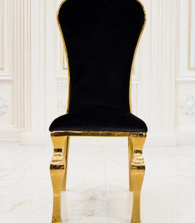 Luxury black velvet dining chair with polished gold stainless steel frame.