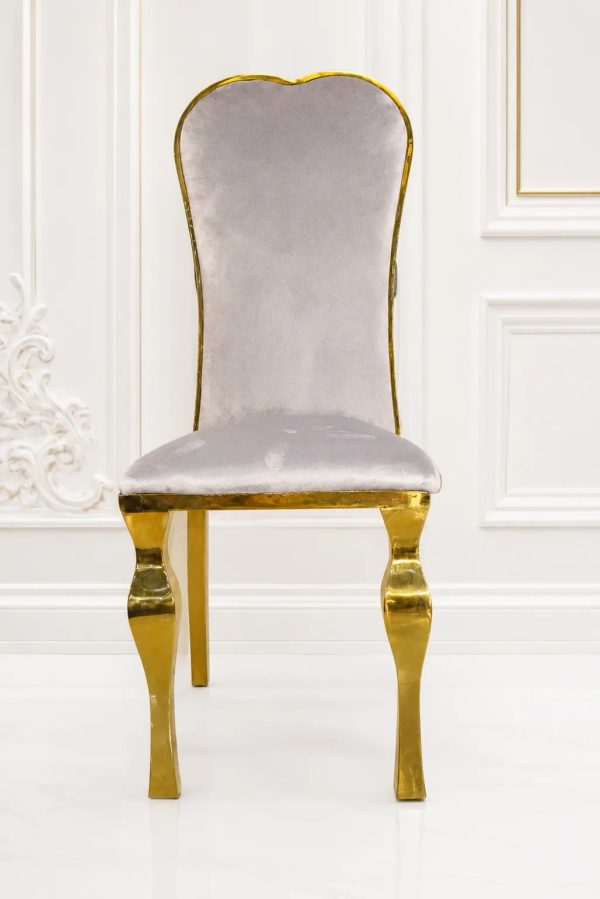 Luxury silver velvet dining chair with polished gold stainless steel frame.