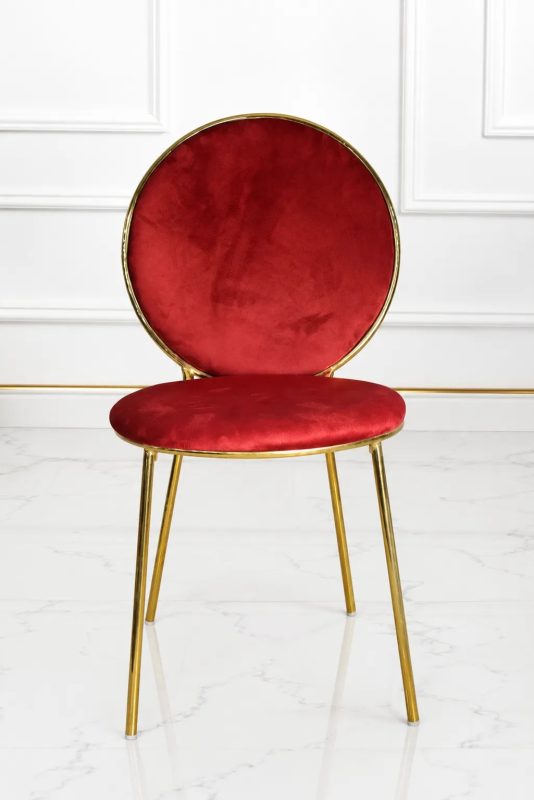 Luxury red velvet dining chair with gold metal frame and round backrest.