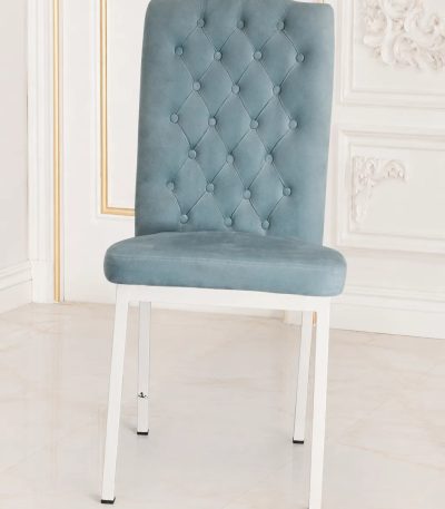 Light blue velvet dining chair with high back and white metal legs.