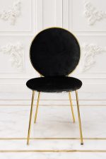 Luxury black velvet dining chair with round back and gold metal frame.