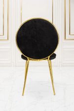 Luxury black velvet dining chair with round back and gold metal frame.