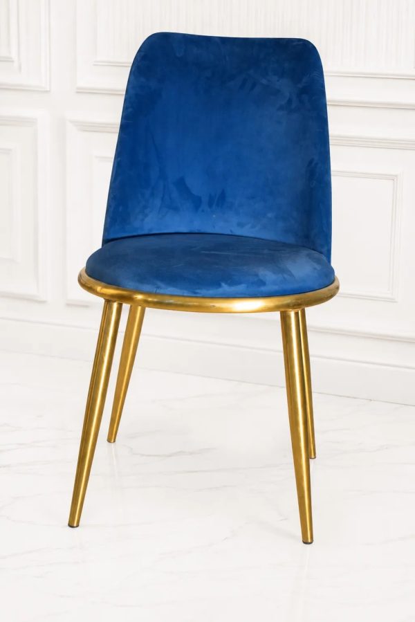 Royal blue velvet dining chair with polished gold metal legs.