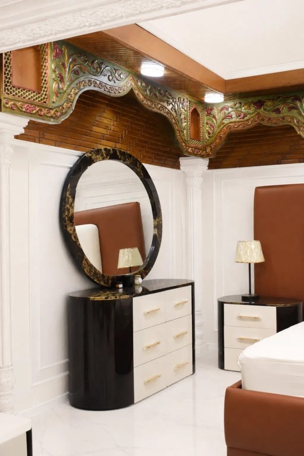 Modern black and white dressing table with round mirror for luxury bedroom.