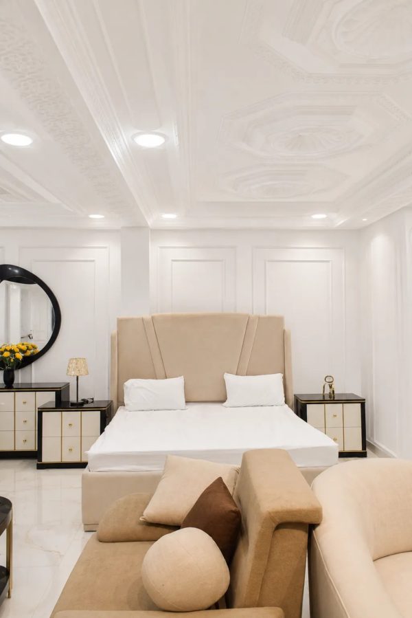 Modern luxury king size upholstered bed set with matching bedside tables.