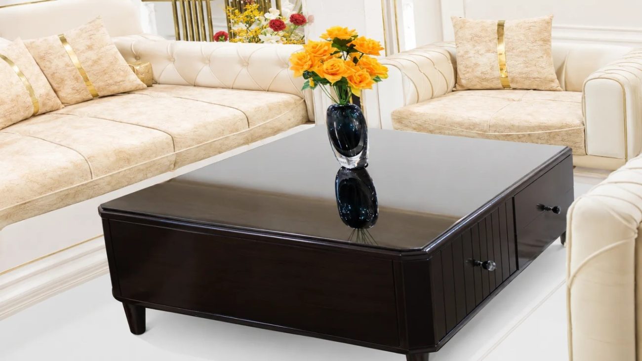 Modern wooden center table with tempered glass top and storage drawers.