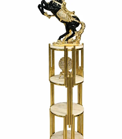 Black and gold rearing horse sculpture with intricate gold detailing on a multi-tier round display stand with gold-tone supports.